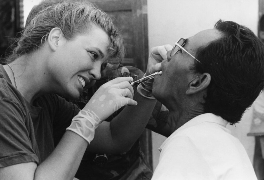 Dental professional providing patient care in a clinical dental setting
