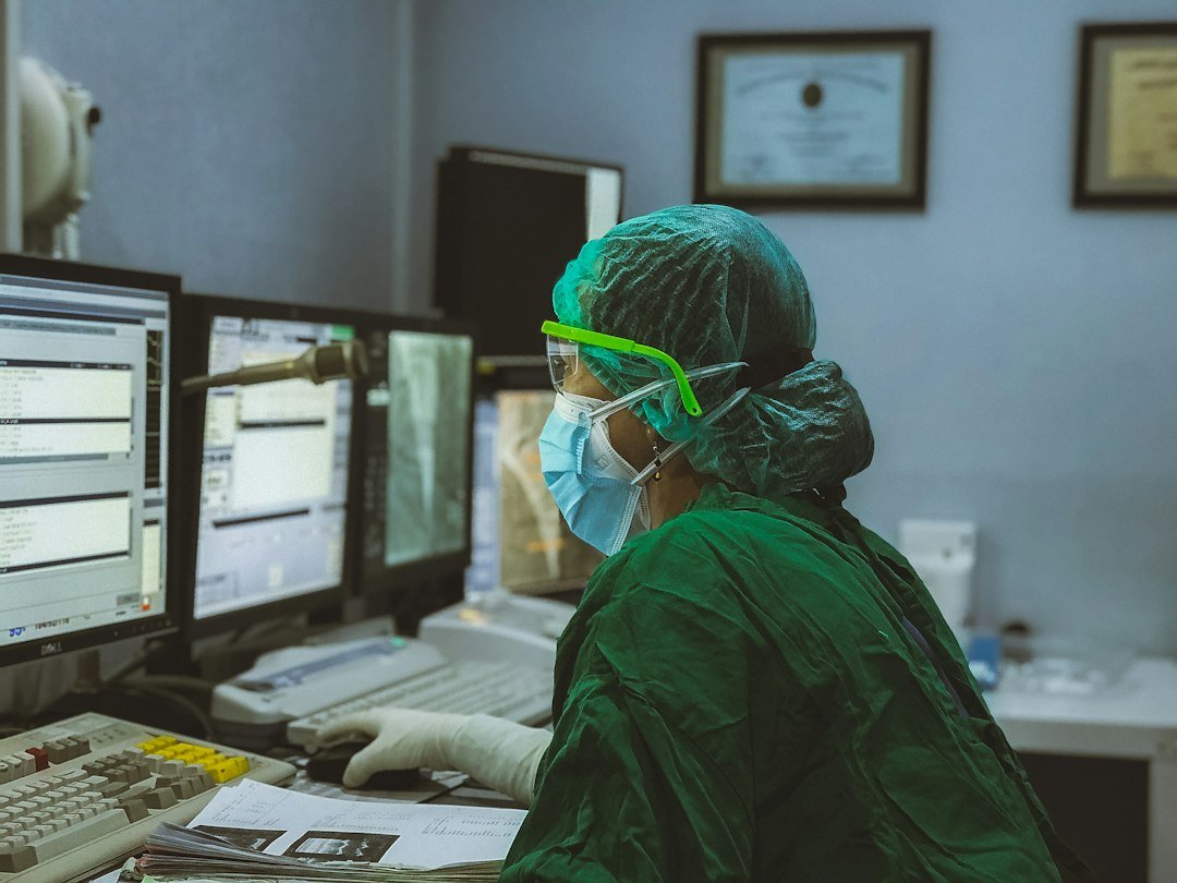 Healthcare professional using technology in a clinical control room