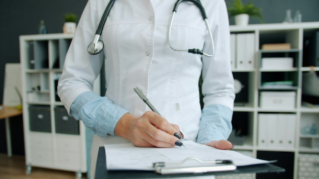 Healthcare professional reviewing documentation for Abu Dhabi professional licensing